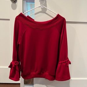 red off the shoulder long sleeve top with cinch/ties on both sleeves